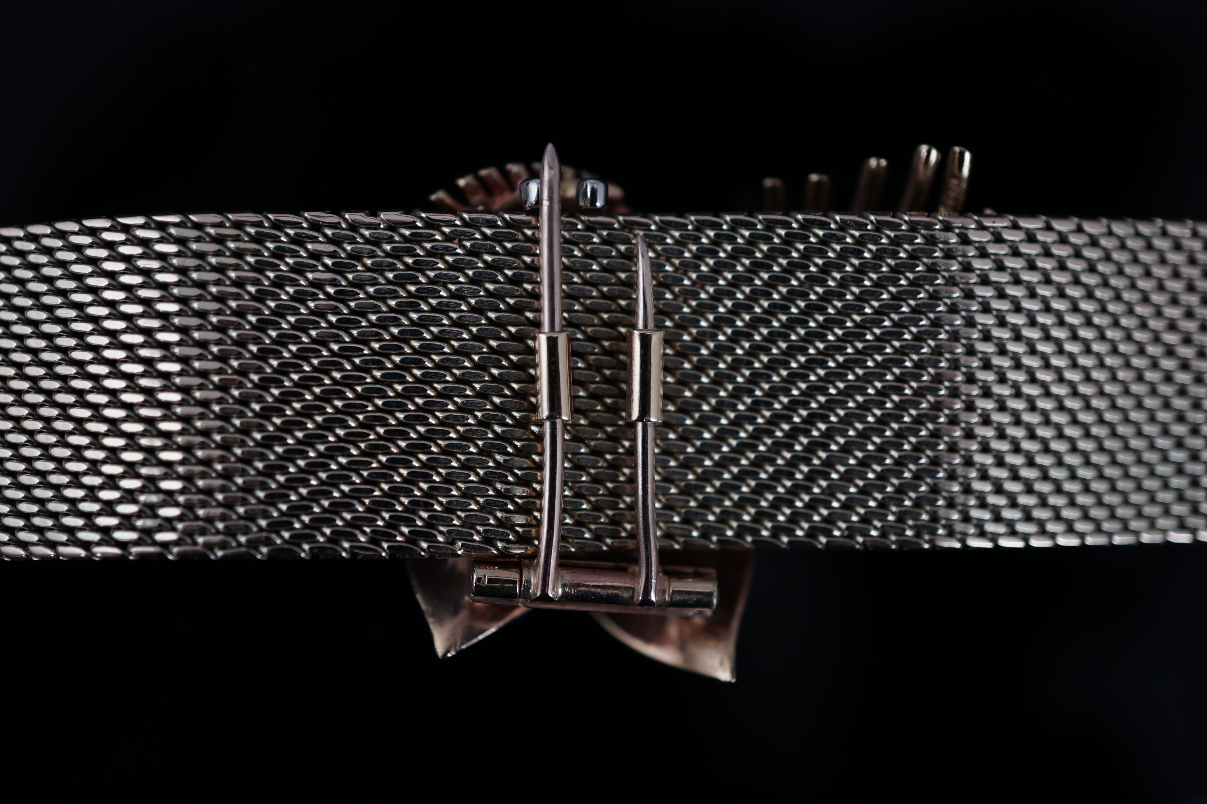 A 1960's 9ct gold ruby and diamond cluster set bracelet, with detachable central foliate scroll clip brooch